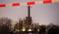 A police cordon is seen in the foreground as police and emergency personnel investigate the site of a fire of high-voltage cables on a bridge near the Lichterfelde power plant (back) on the Teltow Canal in Berlin on January 3, 2026. Photo by Odd ANDERSEN / AFP