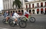 Tourists ride bicycles along a street in Havana on February 2, 2026. (Photo by YAMIL LAGE / AFP)