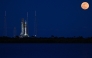 A full moon rises as the Space Launch System (SLS) rocket and the Orion spacecraft, integrated for the Artemis II mission, are seen at the Kennedy Space Center, on February 1, 2026. (Photo by Miguel J. Rodriguez Carrillo / AFP)
 
