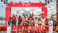The top three teams celebrate on the podium in presence of Qatar Motor & Motorcycle Federation (QMMF) and Lusail International Circuit President Abdulrahman bin Abdullatif Al Mannai and QMMF CEO Amro Al Hamad.