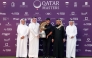 US' Patrick Reed celebrates on the podium with the trophy after winning the Qatar Masters 2026 golf tournament at Doha Golf Club in Doha on February 8, 2026. (Photo by Karim JAAFAR / AFP)
