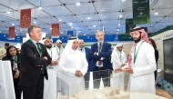 UDST President Dr. Salem Al-Naemi at the University's booth with other officials and participants. 