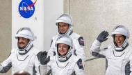 NASA astronauts Jessica Meir (C), commander, and Jack Hathaway (L), pilot, ESA (European Space Agency) astronaut Sophie Adenot (R), and Roscosmos cosmonaut Andrey Fedyaev (2ndL) walk out as they prepare to travel to the SpaceX Falcon 9 rocket with the company's Dragon spacecraft at Space Launch Complex 40 for the Crew-12 mission at Cape Canaveral Space Force Station in Florida, on February 13, 2026. (Photo by Jim WATSON / AFP)