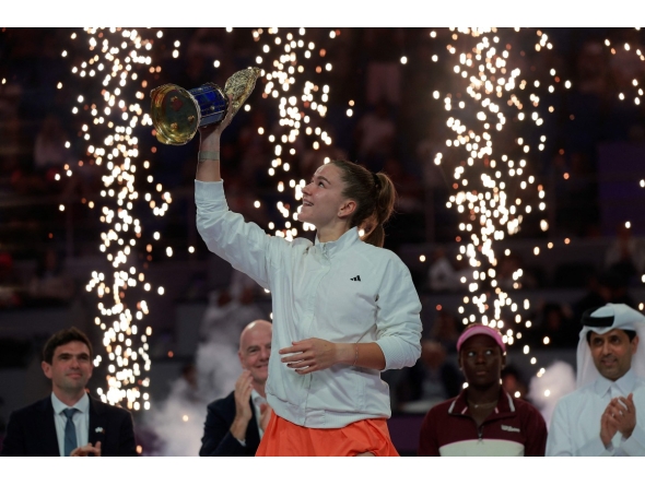 Czech Republic's Karolina Muchova reacts as she holds up the winner's trophy after beating Canada's Victoria Mboko in the women singles final match, at the Qatar Open tennis tournament in Doha on February 14, 2026. (Photo by Karim JAAFAR / AFP)