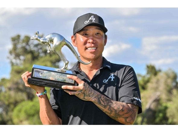 4Aces GC player Anthony Kim from the US celebrates with the trophy after winning the LIV Golf Adelaide tournament at The Grange Golf Club in Adelaide on February 15, 2026. (Photo by Brenton Edwards / AFP)