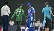 India's captain Suryakumar Yadav (2R) walks past his Pakistan counterpart Salman Agha (2L) after the toss before the start of the 2026 ICC Men's T20 Cricket World Cup group stage match between India and Pakistan at the R Premadasa Stadium in Colombo on February 15, 2026. (Photo by Manan VATSYAYANA / AFP)