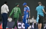 India's captain Suryakumar Yadav (2R) walks past his Pakistan counterpart Salman Agha (2L) after the toss before the start of the 2026 ICC Men's T20 Cricket World Cup group stage match between India and Pakistan at the R Premadasa Stadium in Colombo on February 15, 2026. (Photo by Manan VATSYAYANA / AFP)