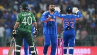 India's Varun Chakravarthy (C) celebrates with wicketkeeper Ishan Kishan after taking the wicket of Pakistan's Abrar Ahmed during the 2026 ICC Men's T20 Cricket World Cup group stage match between India and Pakistan at the R Premadasa Stadium in Colombo on February 15, 2026. (Photo by Ishara S.KODIKARA / AFP)