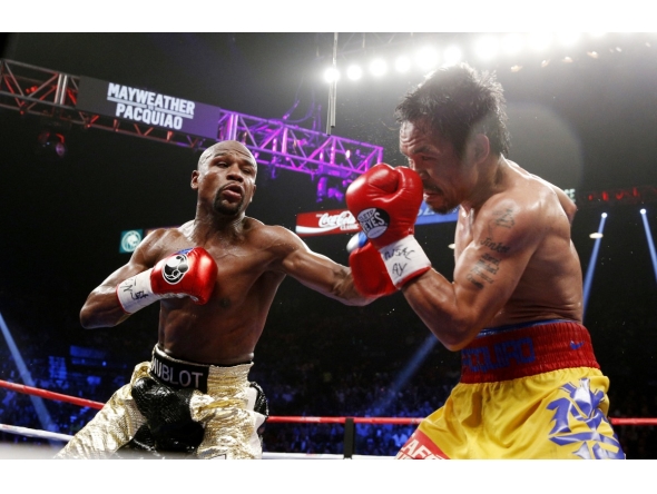 Floyd Mayweather (left) exchange punches with Manny Pacquiao during their welterweight unification championship bout in Las Vegas, Nevada in this in this May 2, 2015 file photo.