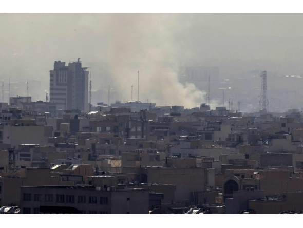 A plume of smoke rises following a reported explosion in Tehran on February 28, 2026. (Photo by Atta Kenare / AFP)