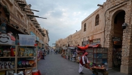 Visitors walk through a bird market at Souq Waqif in Doha on March 4, 2026. Photo by Karim JAAFAR / AFP