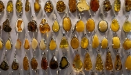 This photo shows jewellery made from natural Baltic amber, on sale at an amber shop on Mariacka Street in Gdansk, Poland on March 10, 2026. (Photo by Wojtek RADWANSKI / AFP)