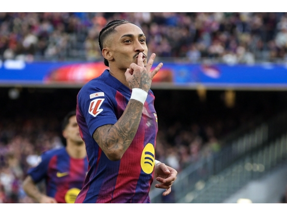Barcelona's Brazilian forward #11 Raphinha celebrates scoring his team's fourth goal and his hat-tick, during the Spanish League football match between FC Barcelona and Sevilla FC at the Camp Nou Stadium in Barcelona, on March 15, 2026. (Photo by Lluis GENE / AFP)
