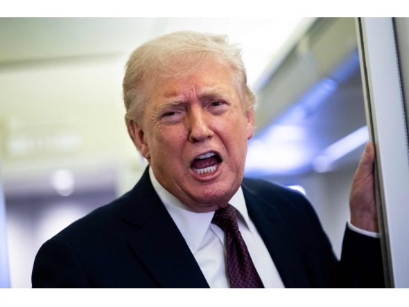 US President Donald Trump speaks to members of the media onboard Air Force One on March 15, 2026 while en route to Joint Base Andrews, Maryland from West Palm Beach Florida. Nathan Howard/Getty Images/AFP 