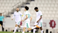 Al Ahli's Younis Abdelrahman (centre) celebrates after scoring a goal against Al Gharafa yesterday.
