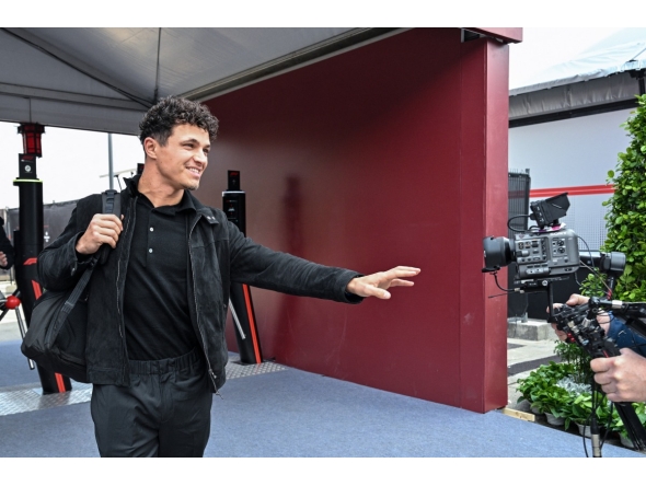 McLaren's British driver Lando Norris arrives to the paddock at the Shanghai International Circuit ahead of the Formula One Chinese Grand Prix in Shanghai on March 12, 2026. (Photo by Hector RETAMAL / AFP)
