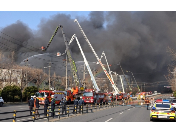 Firefighters spray water to extinguish a fire at a car parts plant in Daejeon on March 20, 2026. (Photo by Yonhap / AFP) 