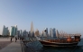 Families walk along the Corniche on the second day of Eid al-Fitr celebrations in Doha on March 21, 2026. (Photo by AFP) 