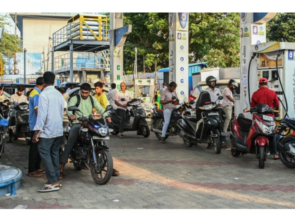 People queue to refuel at a petrol station in Hyderabad on March 25, 2026. Photo by NOAH SEELAM / AFP