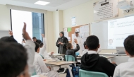 Minister of Education and Higher Education H E Lolwah bint Rashid Al Khater interacts with students in a classroom during her visit to a school yesterday.
