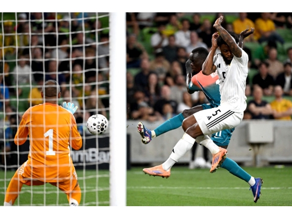 Australia's Awer Mabil (centre) shoots to score against Curacao.