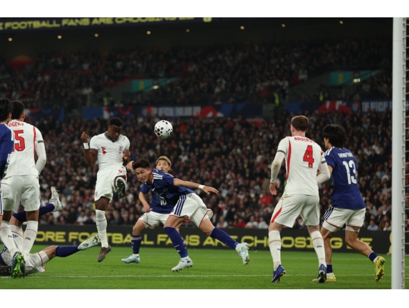 England's defender Marc Guehi (L) heads towards goal during the friendly international football match between England and Japan at Wembley Stadium in London on March 31, 2026. (Photo by Adrian Dennis / AFP) 