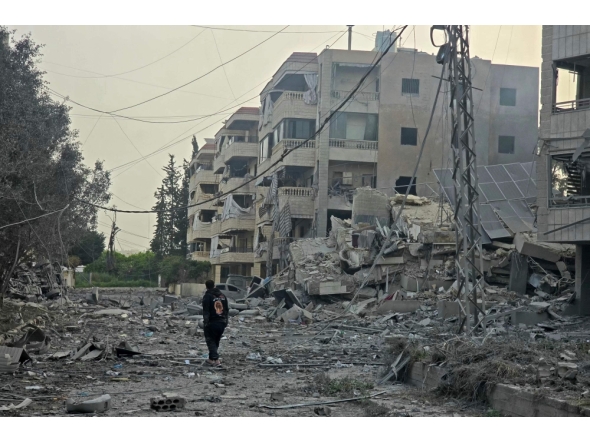 A man walks through the debris of destroyed buildings at the site of an Israeli airstrike in the Al Hosh area near the coastal Lebanese city of Tyre on April 4, 2026. (Photo by Kawnat Haju / AFP)