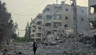 A man walks through the debris of destroyed buildings at the site of an Israeli airstrike in the Al Hosh area near the coastal Lebanese city of Tyre on April 4, 2026. (Photo by Kawnat Haju / AFP)
