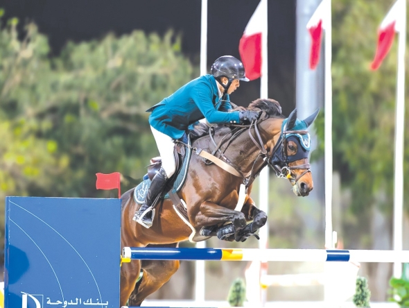 Saudi Arabian rider Abdullah Alsharbatly guides Frenchy Vds over a fence. 