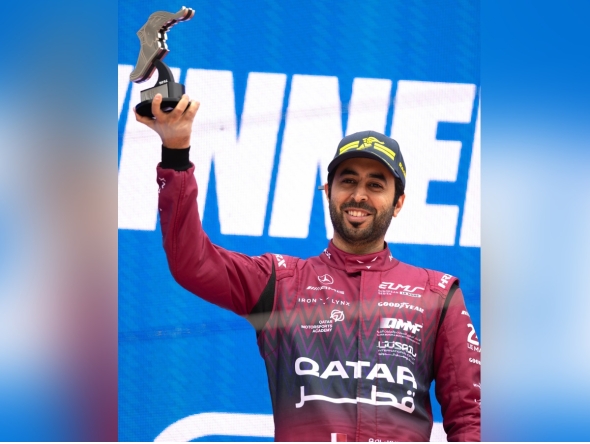Qatari driver Abdulla Al Khelaifi celebrates on the podium after winning the Most Valuable Driver award in the LMGT3 class.