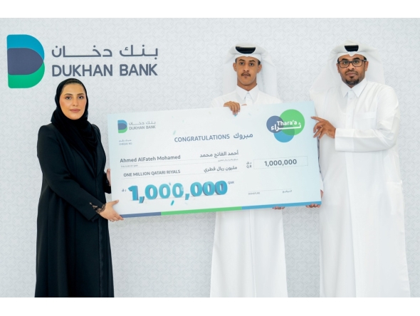A Dukhan Bank official with the winner of the Thara'a campaign.