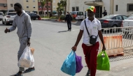 Senegal football supporters walk with their personal belongings after being released from Al Arjat 2 prison in Sale on April 18, 2026.(Photo by Abdel Majid BZIOUAT / AFP)
 