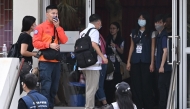 Residents of Wang Fuk Court residential estate arrive to return to their apartments in Hong Kong on April 20, 2026. Photo by Peter PARKS / AFP