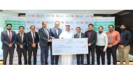 Regional Director of LuLu Hypermarket Qatar, Shanavas P M, presenting a cheque to Deputy Director of Donor Relations at Qatar Charity, Amer Mohammed AlBesiri.