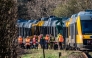 DENMARK-TRANSPORT-RAILWAY-ACCIDENT
Rescue workers stand near two trains that collided between the towns of Hillerod and Kagerup, north of Copenhagen, leaving many injured, on April 23, 2026. The accident happened between the towns of Hillerod and Kagerup, about 40 kilometers (25 miles) from Copenhagen. 
(Photo by Steven Knap / Ritzau Scanpix / AFP) / Denmark 