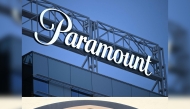 (COMBO) This combination of files pictures created on December 22, 2025 shows the Paramount logo (TOP) displayed at Columbia Square along Sunset Blvd in Hollywood, California on March 9, 2023 and the WB logo on the exterior of Warner Bros. Studios, Burbank in Burbank, California on October 21, 2025. Photo by Patrick T. Fallon and Robyn Beck / AFP