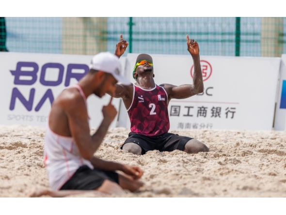 Qatar's Ahmed Tijan (right) celebrates during the match against Iran.