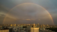 A general view shows the city skyline and a rainbow from the Tokyo Metropolitan Government Building observation deck in the Shinjuku district of central Tokyo on April 27, 2026. (Photo by Philip FONG / AFP)