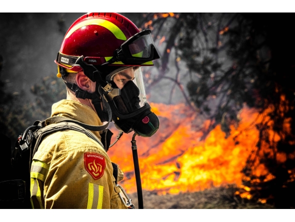 A firefighter works to extinguish a wildfire near Budel, on May 1, 2026 a day after it broke out at a military training ground where a military exercise was taking place. (Photo by ROB ENGELAAR / ANP / AFP)