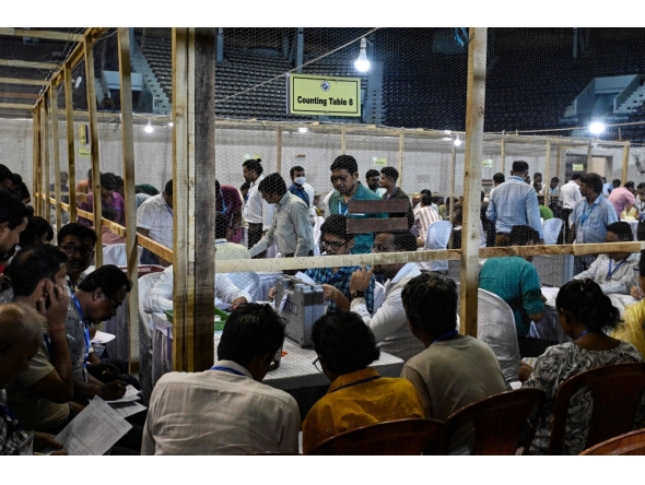 Election officials count votes after the West Bengal Legislative Assembly elections at the Netaji Indoor Stadium in Kolkata on May 4, 2026. 
 (Photo by Dibyangshu SARKAR / AFP)