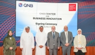 CEO of QNB Group Abdulla Mubarak Al-Khalifa and Dean of CMU-Q Michael Trick with representatives from both institutions during the signing of MoU, yesterday. PIC: MOHAMED ATTAR/THE PENINSULA