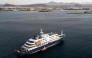 This aerial view shows health personnel boarding the cruise ship MV Hondius, while stationary off the port of Praia, the capital of Cape Verde, on May 6, 2026. Photo by AFP