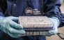 This handout picture released by Argentina's Health Ministry shows a scientist from the Malbran Institute handling containers used to diagnose the Andes hantavirus, which contain RNA from the Andes virus as part of the detection process, in Buenos Aires on May 6, 2026. (Photo by Handout / ARGENTINE HEALTH MINISTRY / AFP)