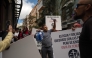 Dockers hold banners reading 'Without protocol, no safety' as they protest against the arrival of a cruise ship affected by hantavirus in Santa Cruz de Tenerife on May 8, 2026. Photo by JORGE GUERRERO / AFP