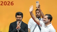 Newly elected chief minister of India's Tamil Nadu state, C. Joseph Vijay (L) along with Indian National Congress (INC) party leader Rahul Gandhi (R) greets supporters after taking the oath during his swearing-in ceremony in Chennai on May 10, 2026. (Photo by R.Satish BABU / AFP)