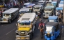 In this photo taken on April 5, 2024, jeepneys commute along a street in Manila. (Photo by Ted ALJIBE / AFP)