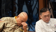 Philippine Senator Ronald dela Rosa (L) gestures next to colleague Christopher Go during a Senate plenary session on the third day of him holed up in the Senate building in Manila on May 13, 2026. Photo by TED ALJIBE / AFP