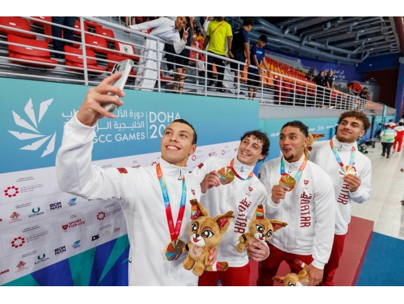 Members of Qatar's men's 400m freestyle relay team celebrate with a selfie after winning the gold medal.
