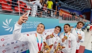 Members of Qatar's men's 400m freestyle relay team celebrate with a selfie after winning the gold medal.