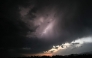A general view shows the Himalayas' Dhauladhar mountain range as lightning strikes across the sky above Dharamsala on May 13, 2026. (Photo by Sajjad HUSSAIN / AFP)